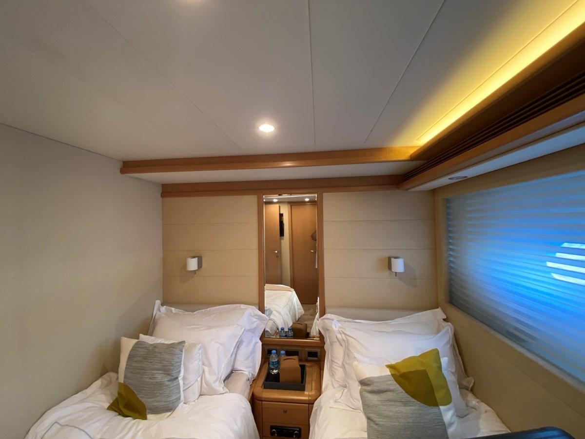 a room with a bed and a window aboard ADF Yacht for Sale