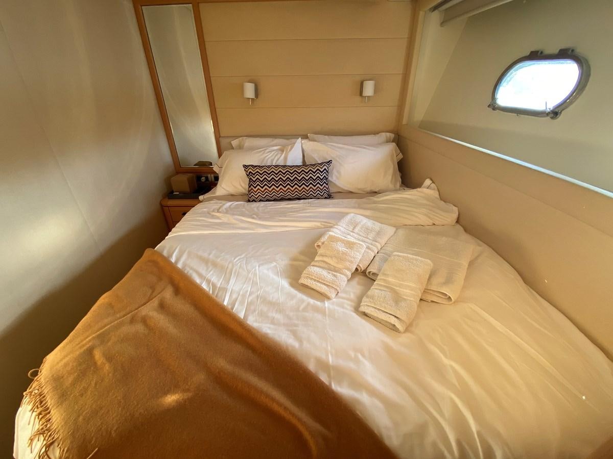 a bed with a bed and a mirror aboard ADF Yacht for Sale