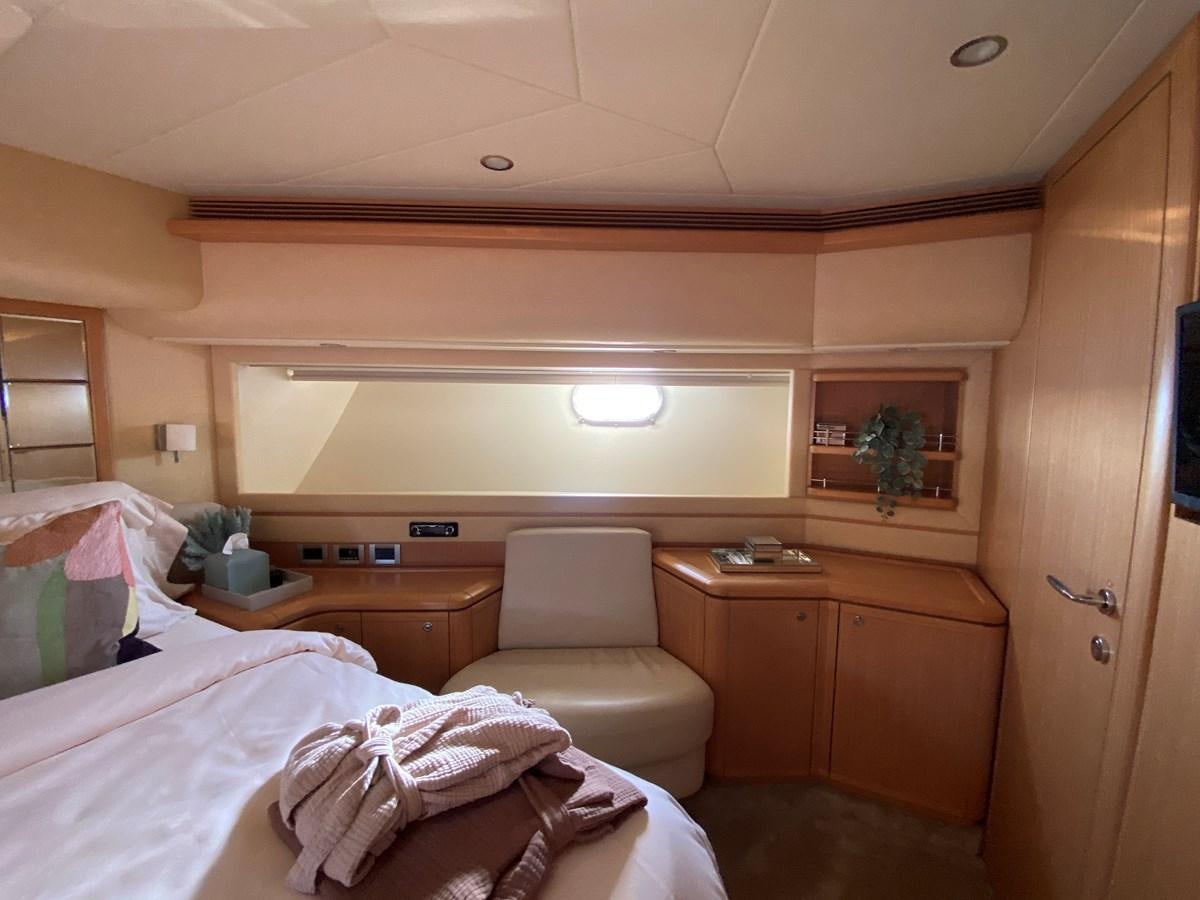 a room with a bed and a chair aboard ADF Yacht for Sale
