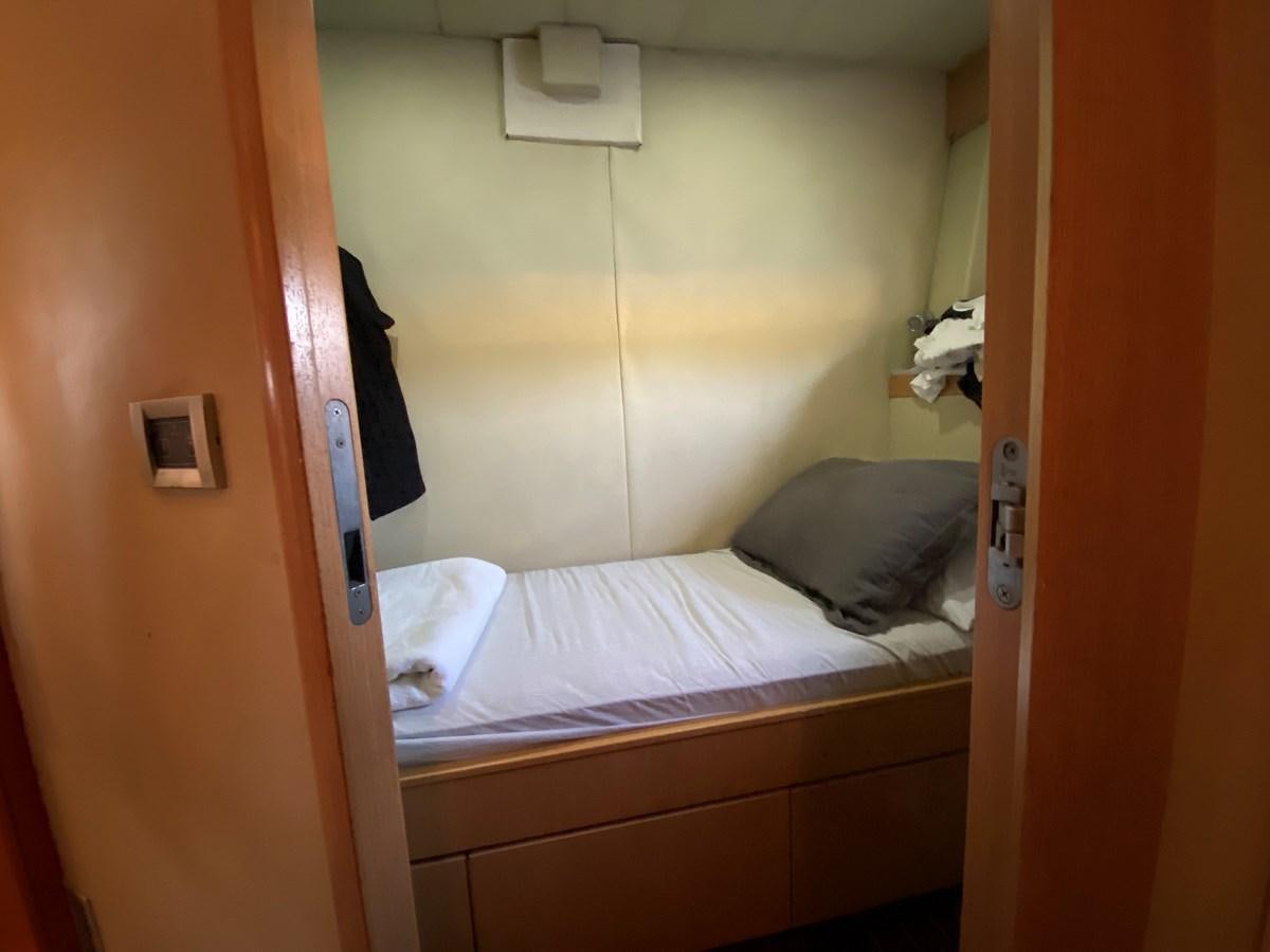 a bed with a white sheet aboard ADF Yacht for Sale