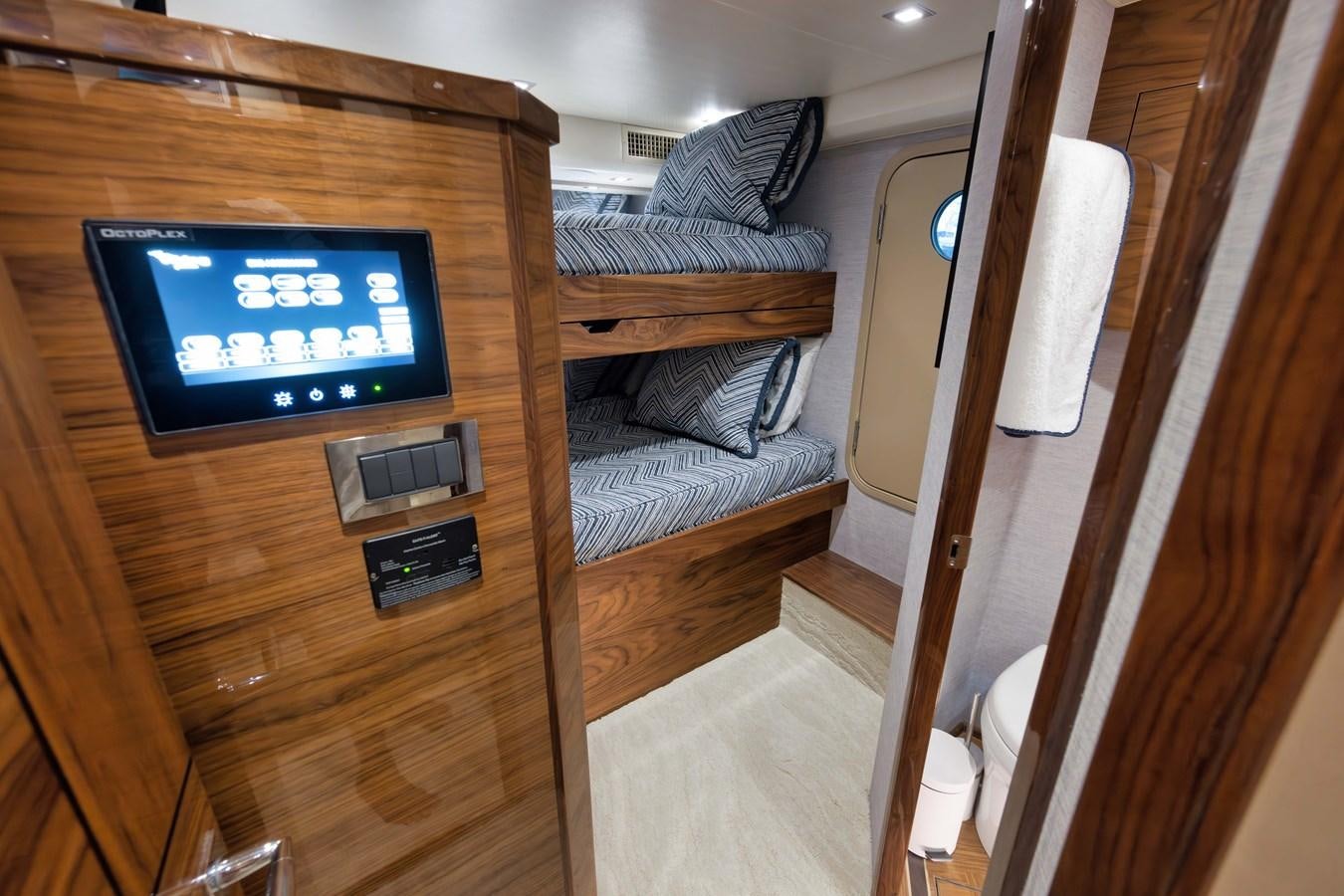 a room with a tv and a bed aboard MISS CARRIE Yacht for Sale