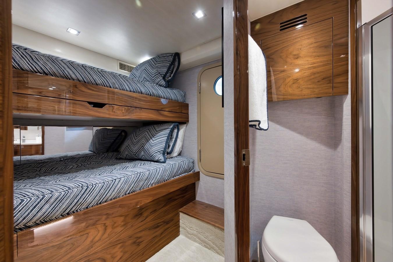 a bedroom with a bed and a wood door aboard MISS CARRIE Yacht for Sale