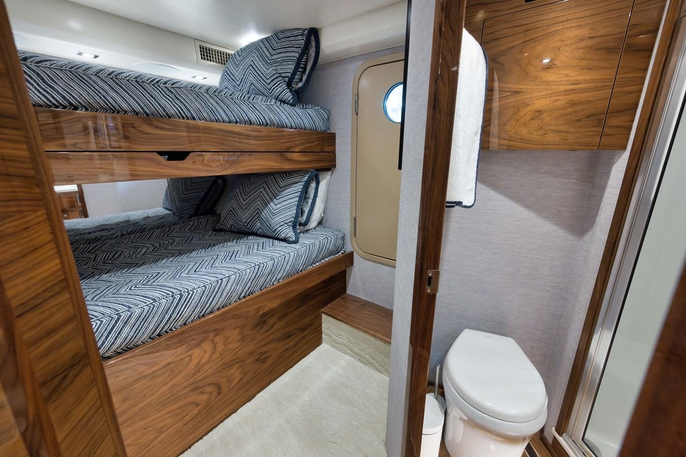 a small bedroom with a bed aboard MISS CARRIE Yacht for Sale