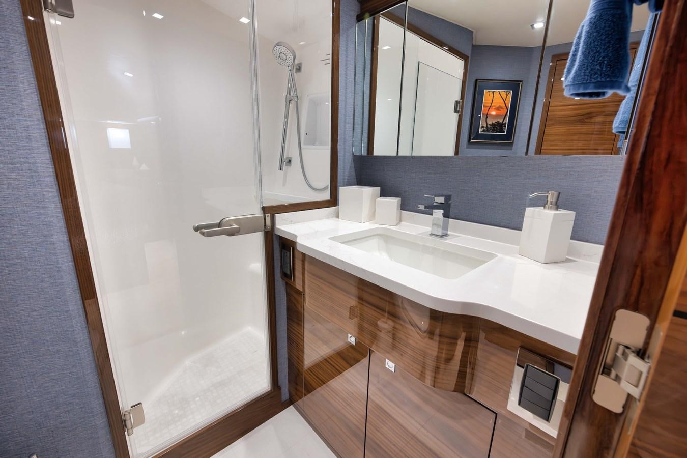 a bathroom with a sink and a mirror aboard MISS CARRIE Yacht for Sale