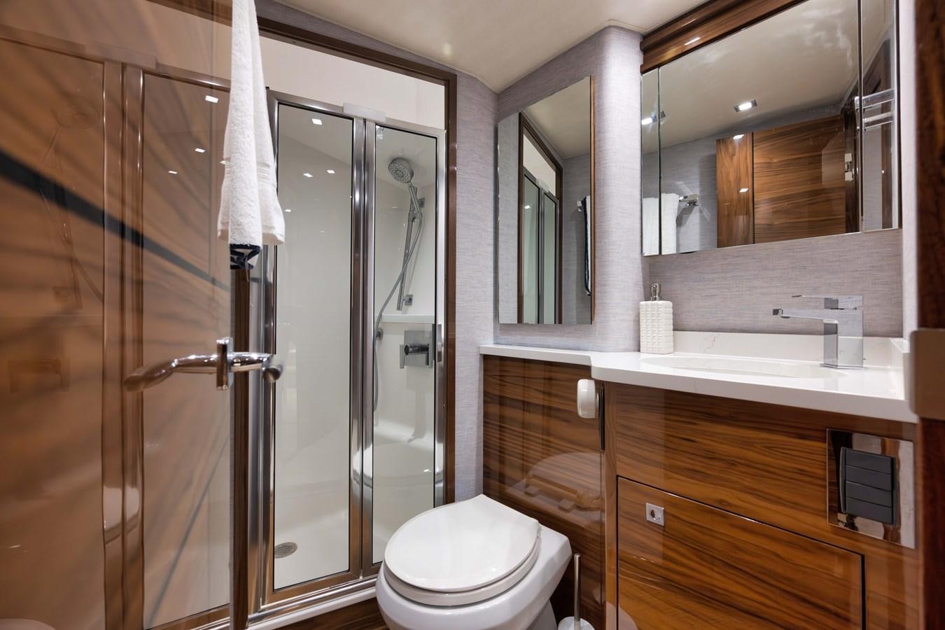 a bathroom with a glass shower aboard MISS CARRIE Yacht for Sale