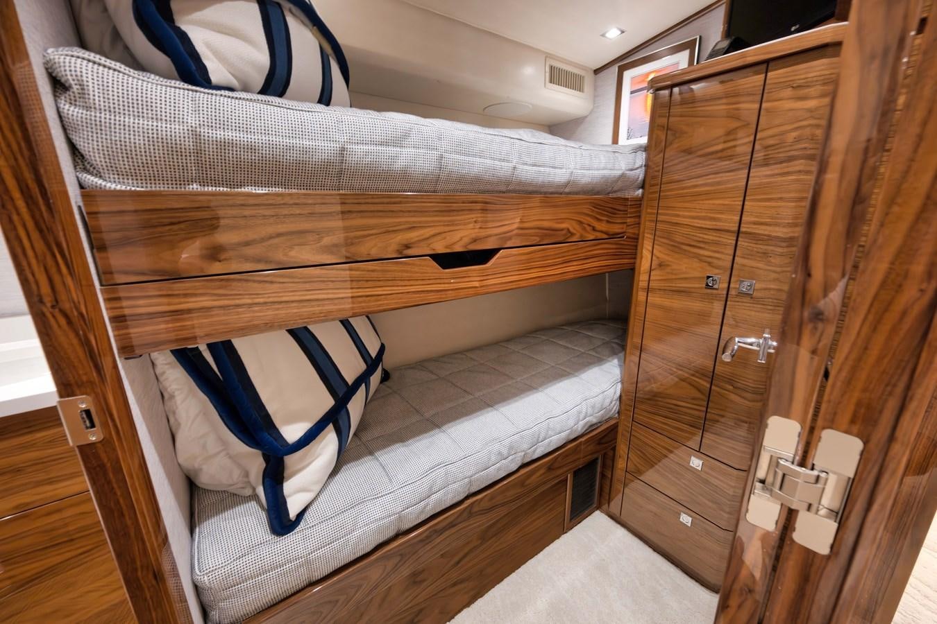 a bed with a blue blanket aboard MISS CARRIE Yacht for Sale