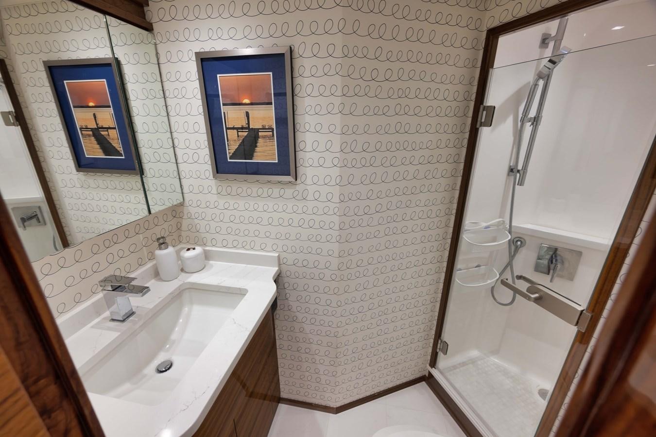a bathroom with a sink and a shower aboard MISS CARRIE Yacht for Sale