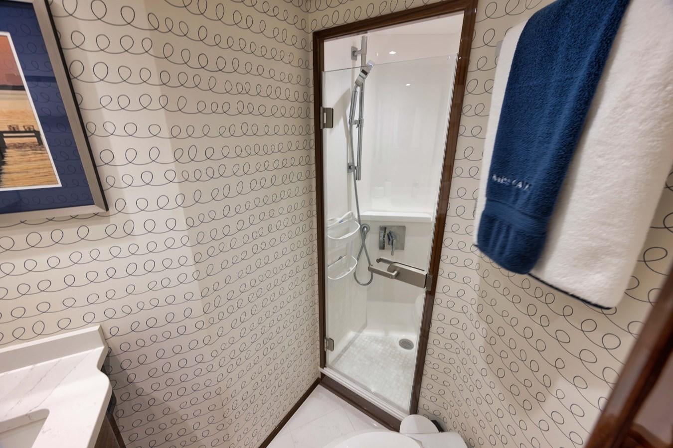 a bathroom with a mirror and a towel on the wall aboard MISS CARRIE Yacht for Sale
