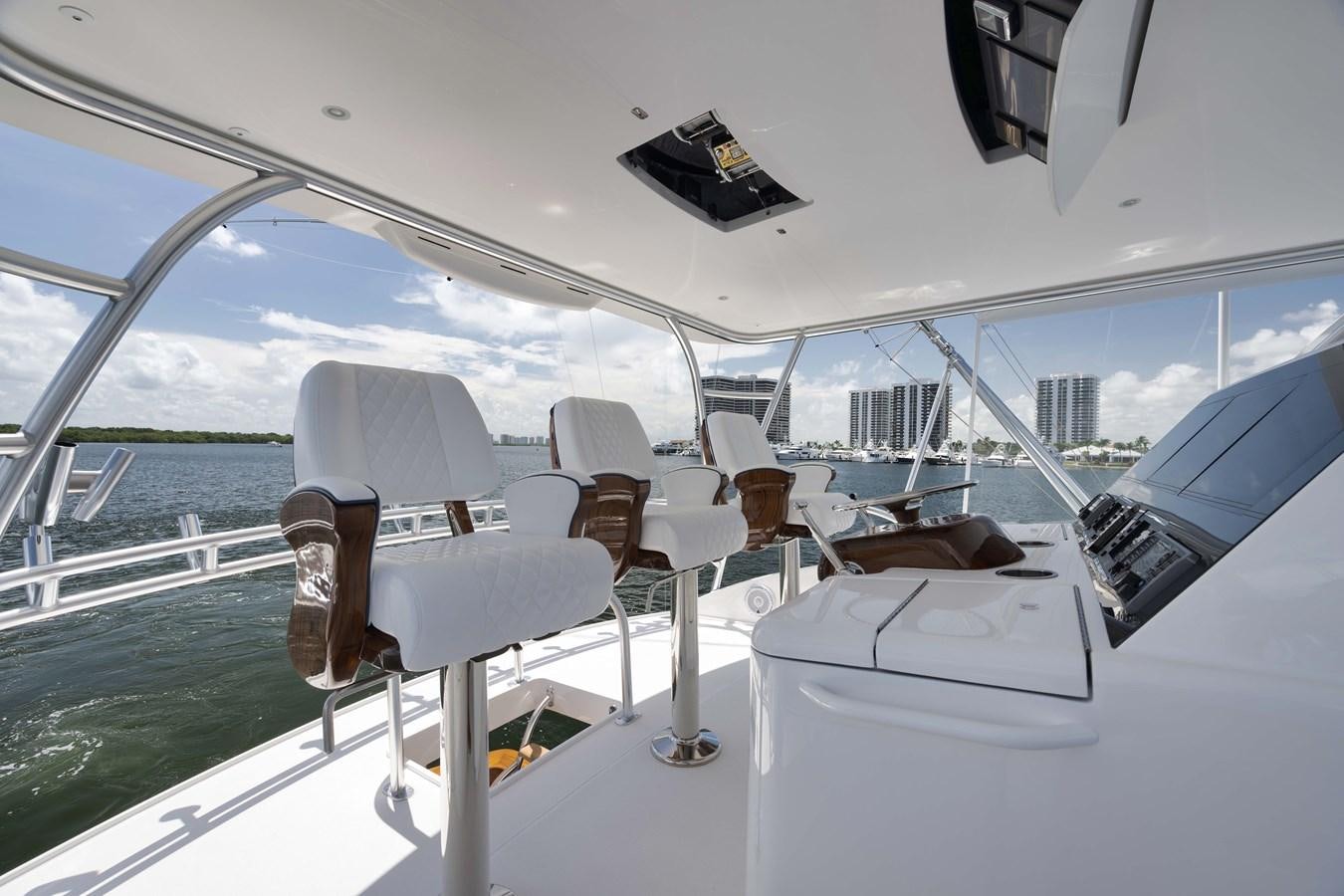 a boat with chairs and a computer on the deck aboard MISS CARRIE Yacht for Sale