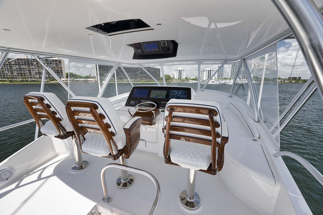 a boat with a table and chairs on it aboard MISS CARRIE Yacht for Sale