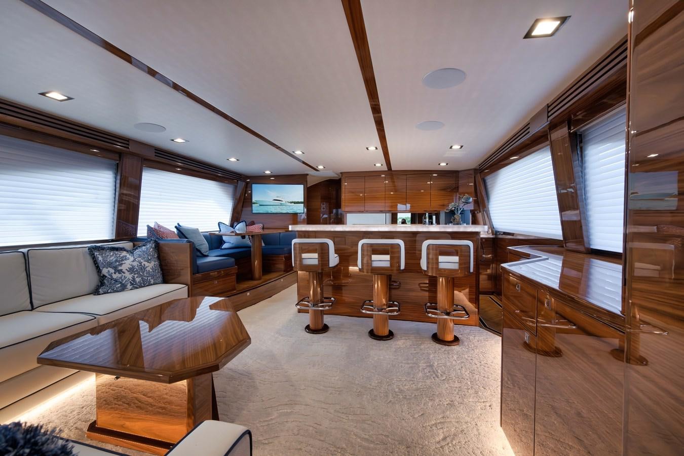 a room with a couch and a table and chairs aboard MISS CARRIE Yacht for Sale