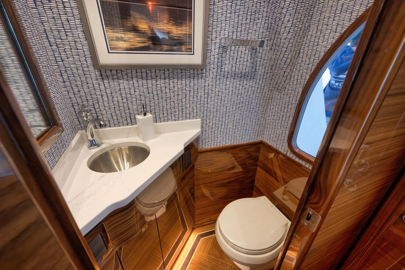 a bathroom with a sink and toilet aboard MISS CARRIE Yacht for Sale