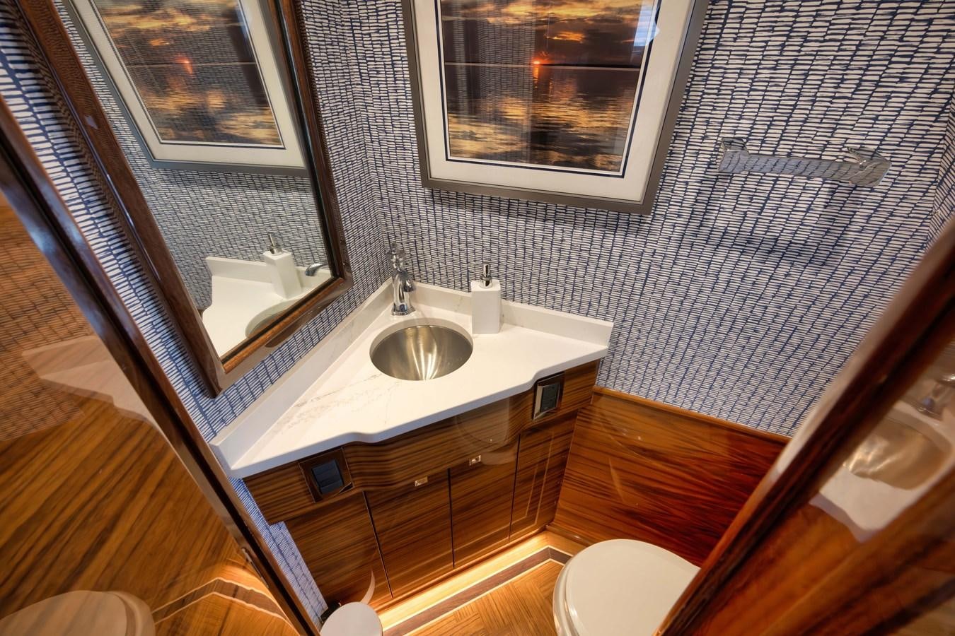 a bathroom with a sink and a mirror aboard MISS CARRIE Yacht for Sale