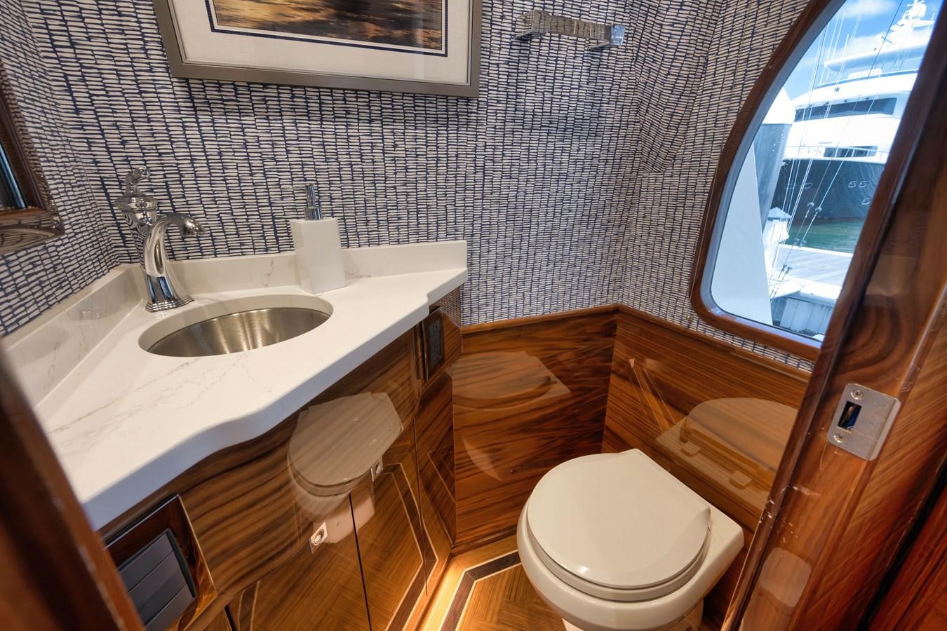a bathroom with a sink and a toilet aboard MISS CARRIE Yacht for Sale