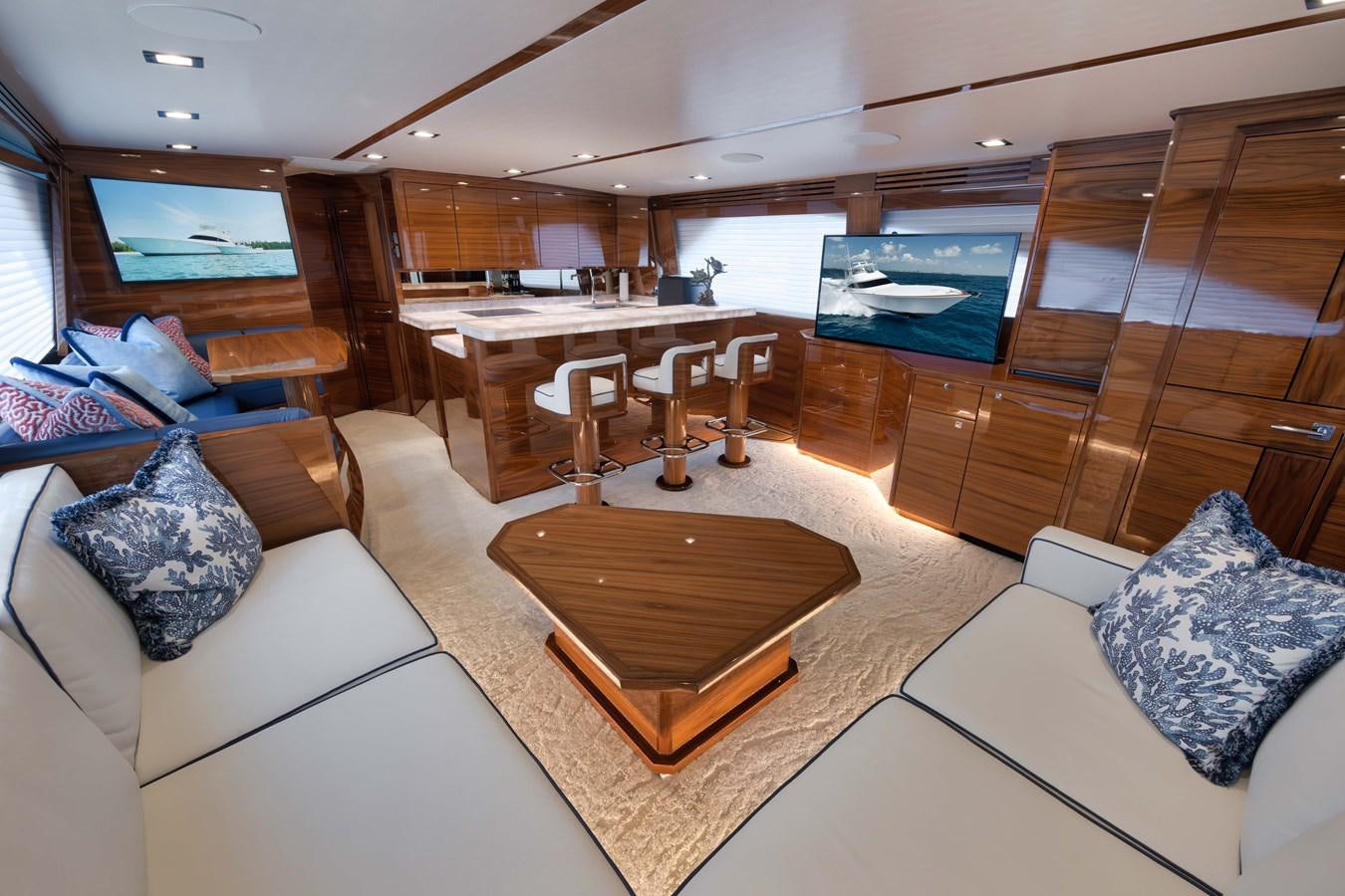 a living room with a wood table aboard MISS CARRIE Yacht for Sale