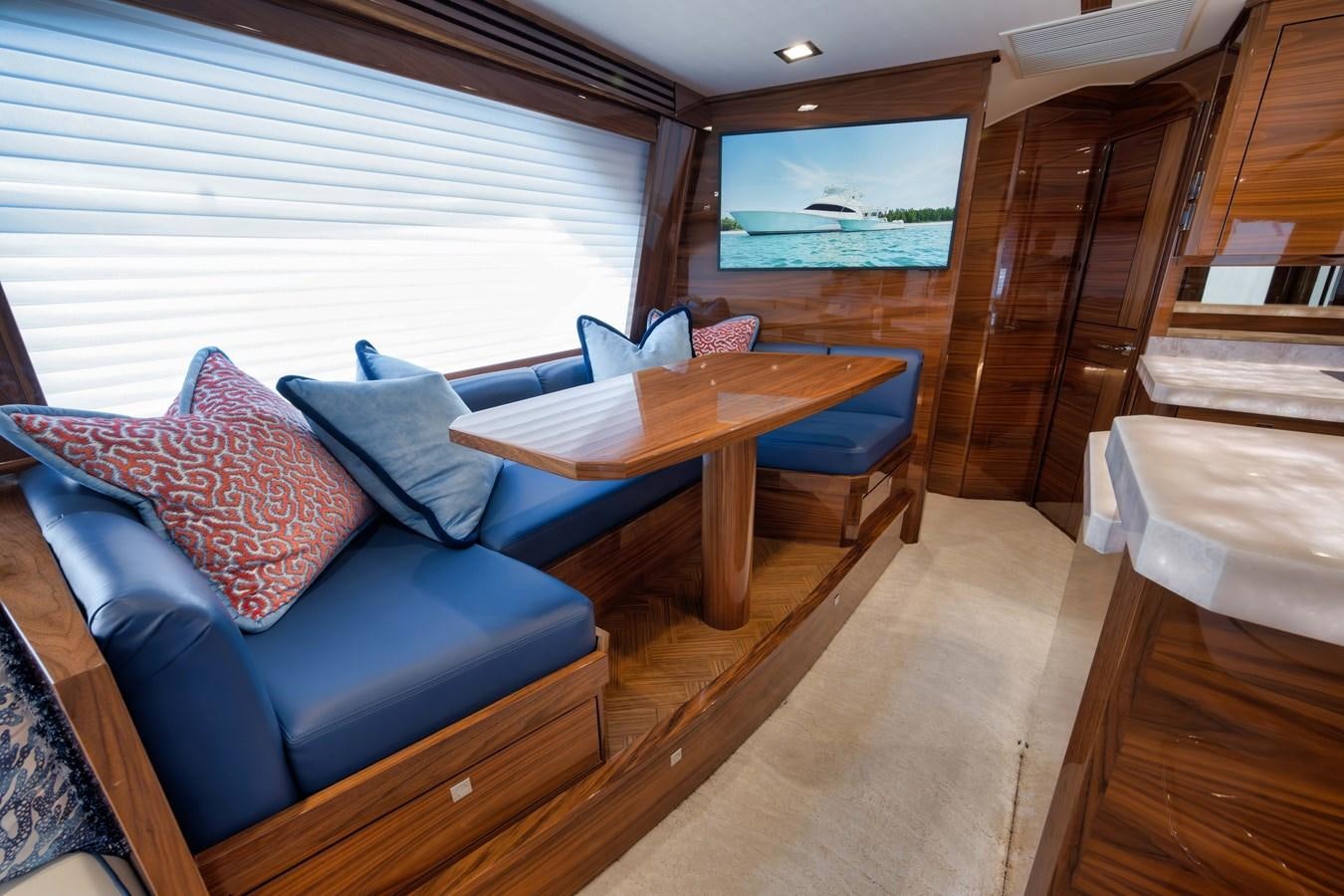 a living room with a couch and a table aboard MISS CARRIE Yacht for Sale