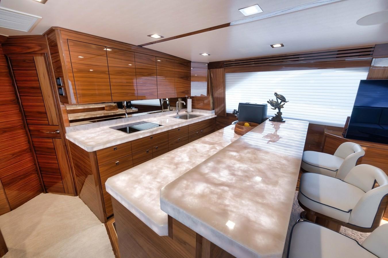 a large kitchen with wooden cabinets aboard MISS CARRIE Yacht for Sale