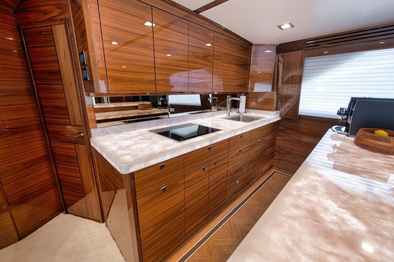 a kitchen with wooden cabinets aboard MISS CARRIE Yacht for Sale