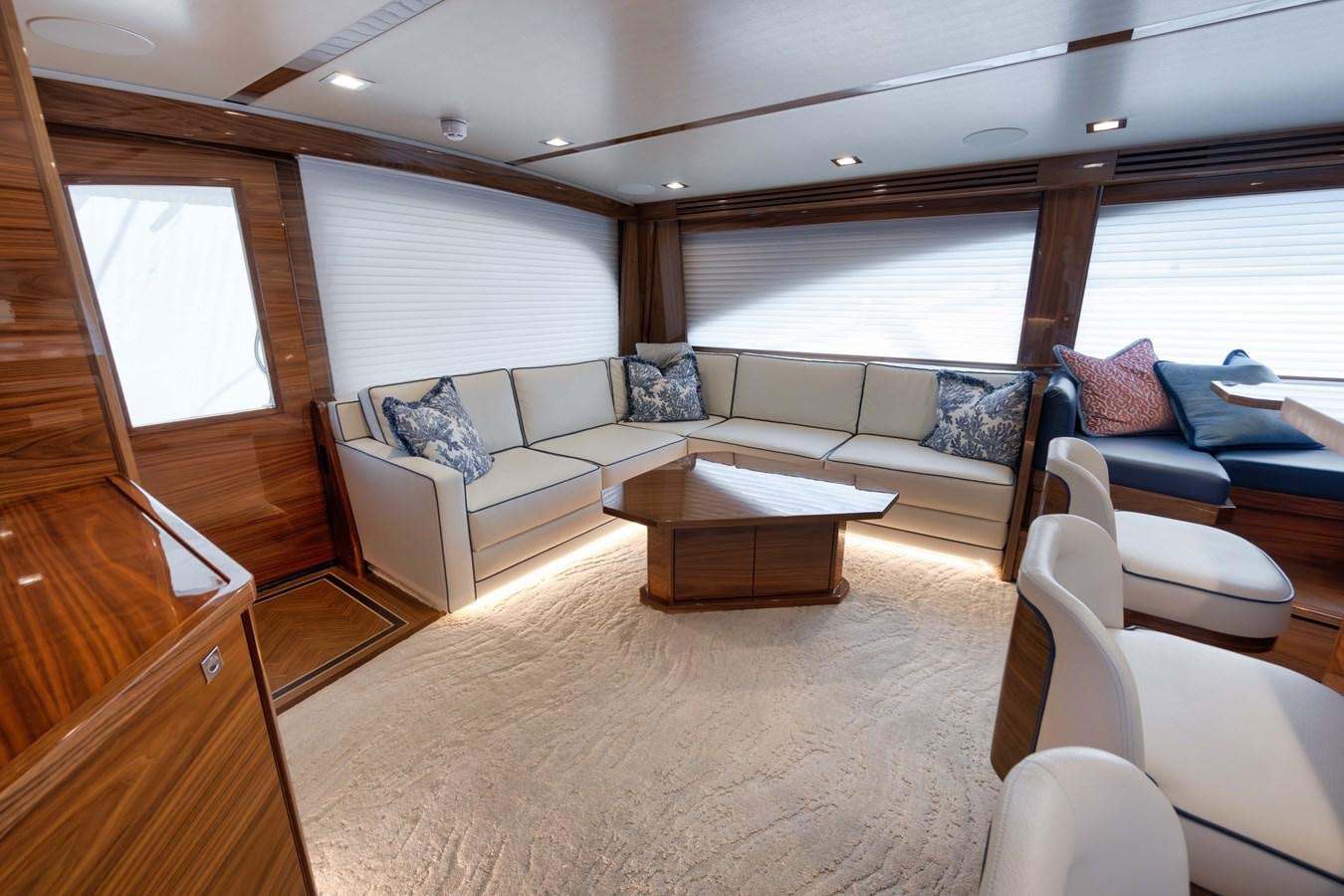 a living room with a couch and a coffee table aboard MISS CARRIE Yacht for Sale