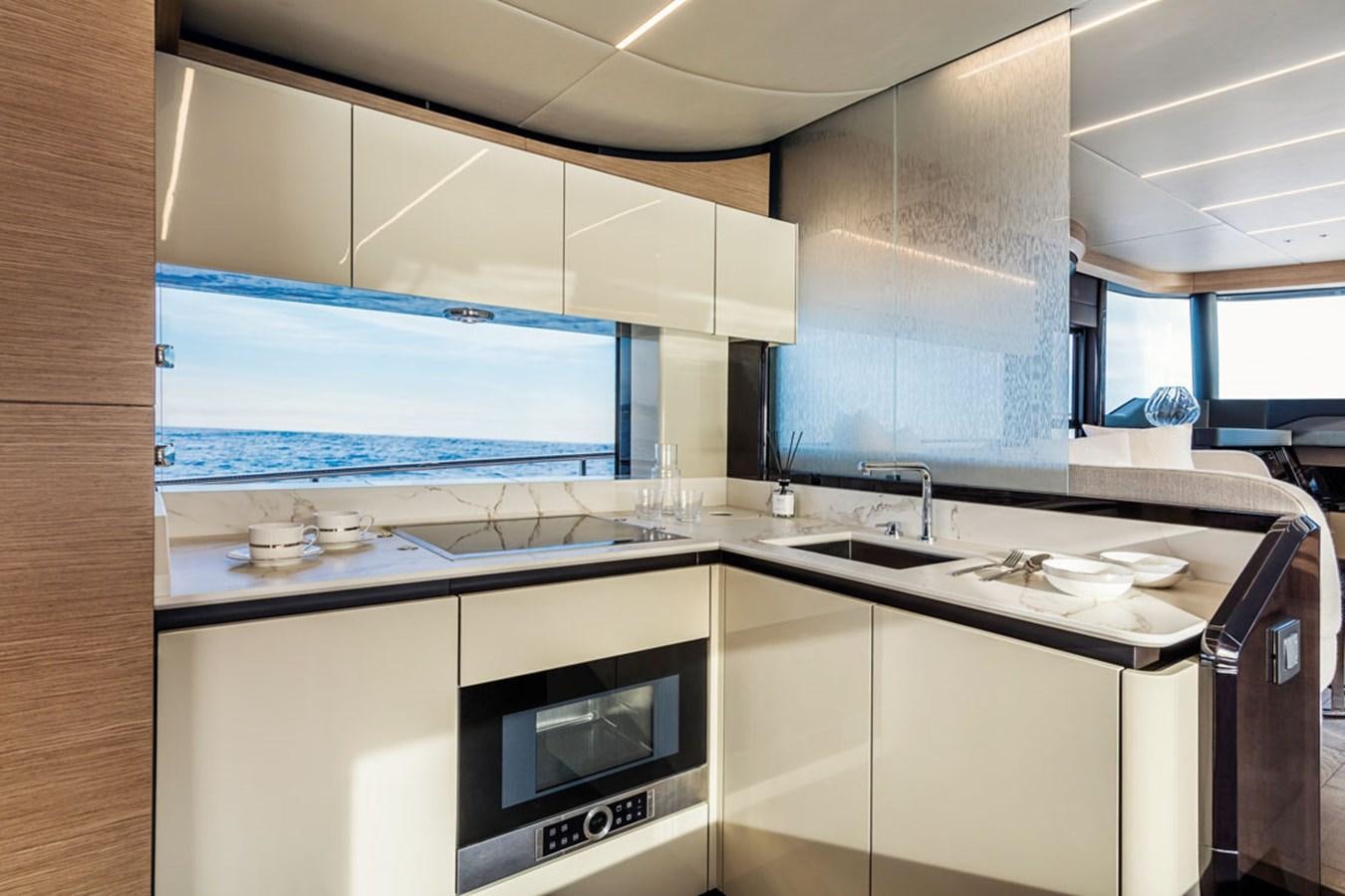 a kitchen with a large tv aboard NAVETTA 75 Yacht for Sale