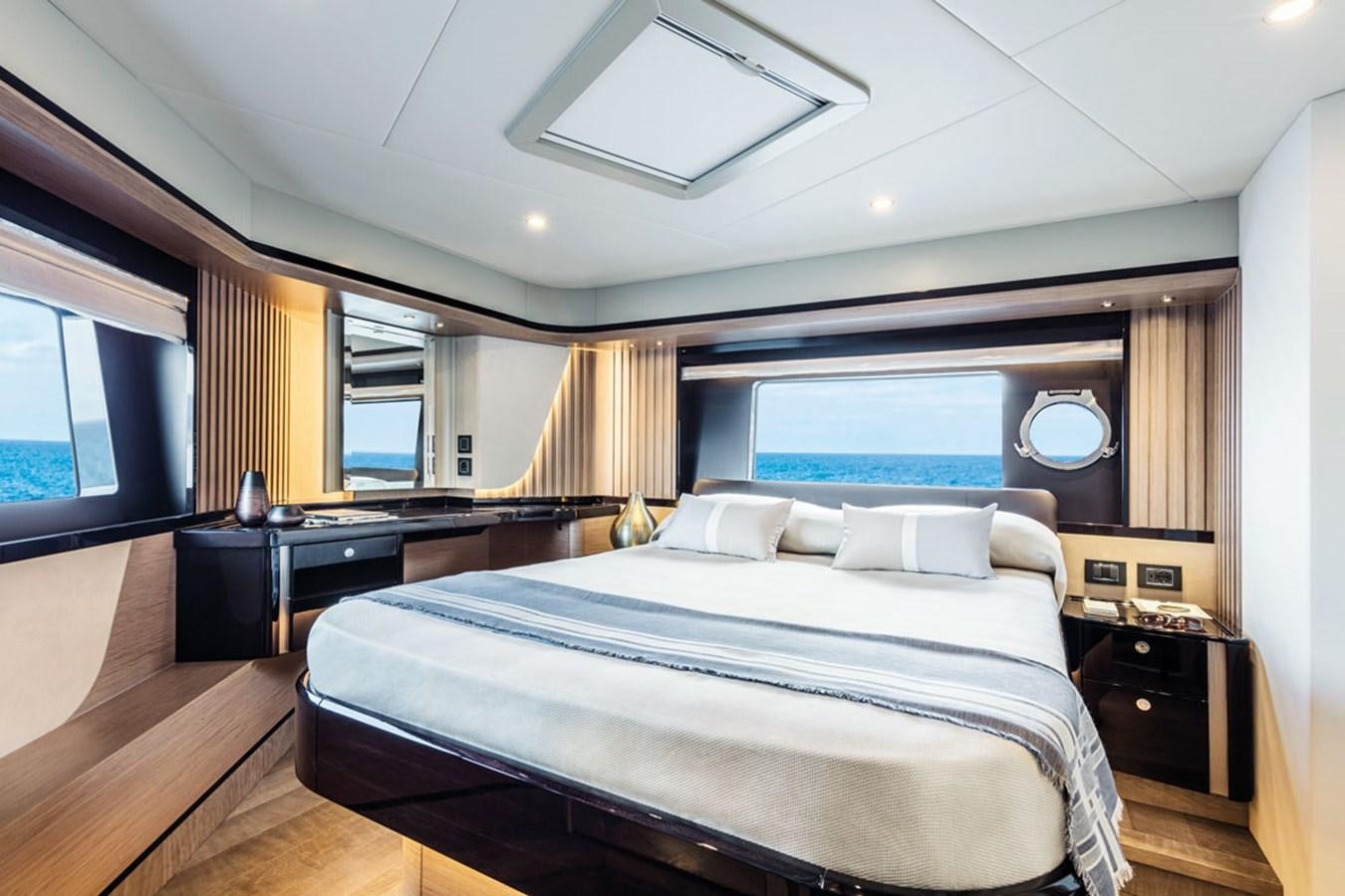 a bedroom with a bed and a desk aboard NAVETTA 75 Yacht for Sale