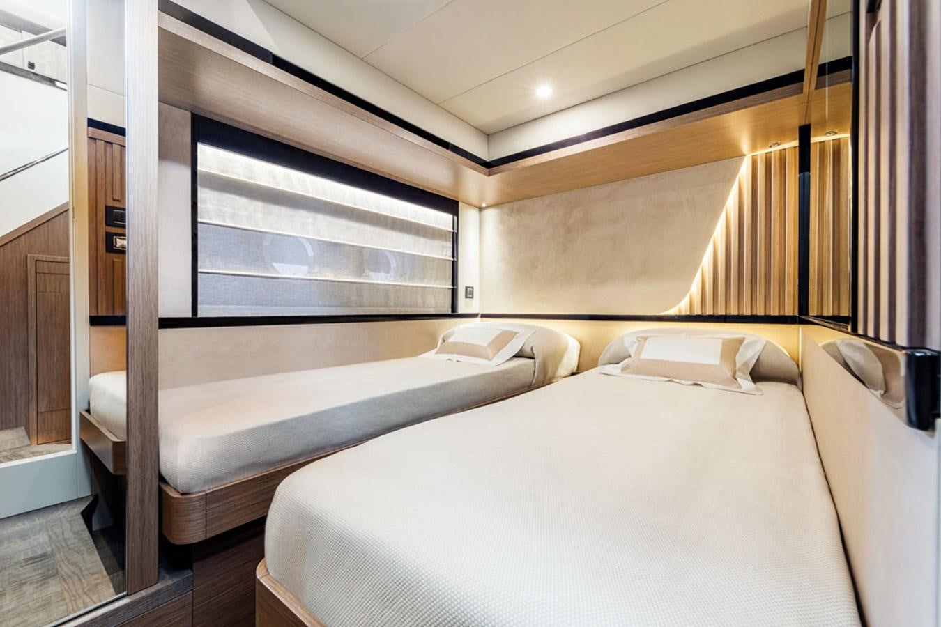 a room with a bed and a window aboard NAVETTA 75 Yacht for Sale