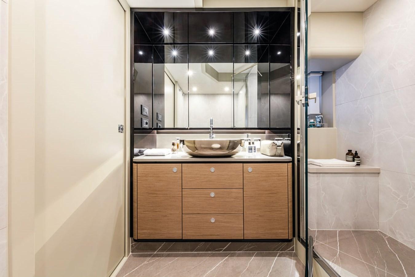 a bathroom with a sink and a mirror aboard NAVETTA 75 Yacht for Sale