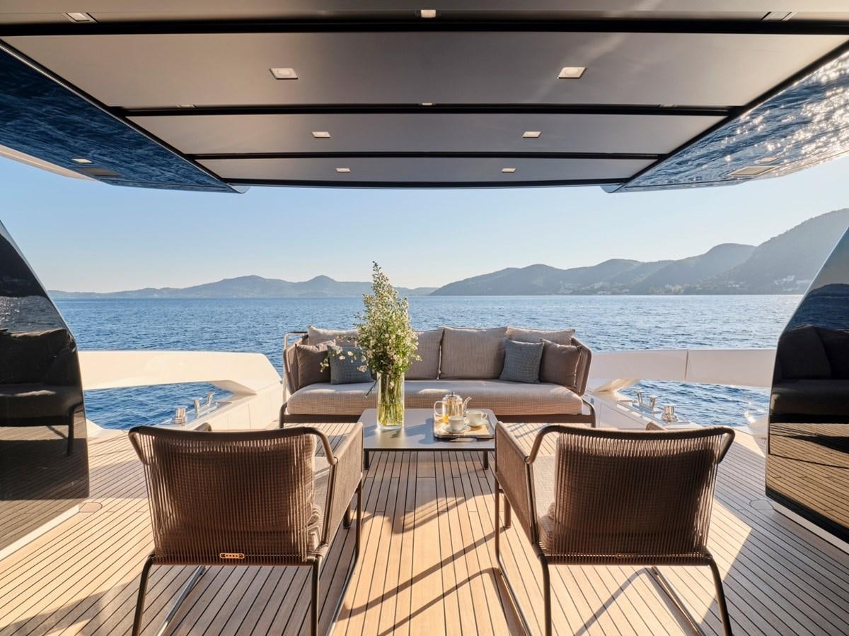 a large patio with a table and chairs on it aboard 2022 SANLORENZO SX76 #72 Yacht for Sale