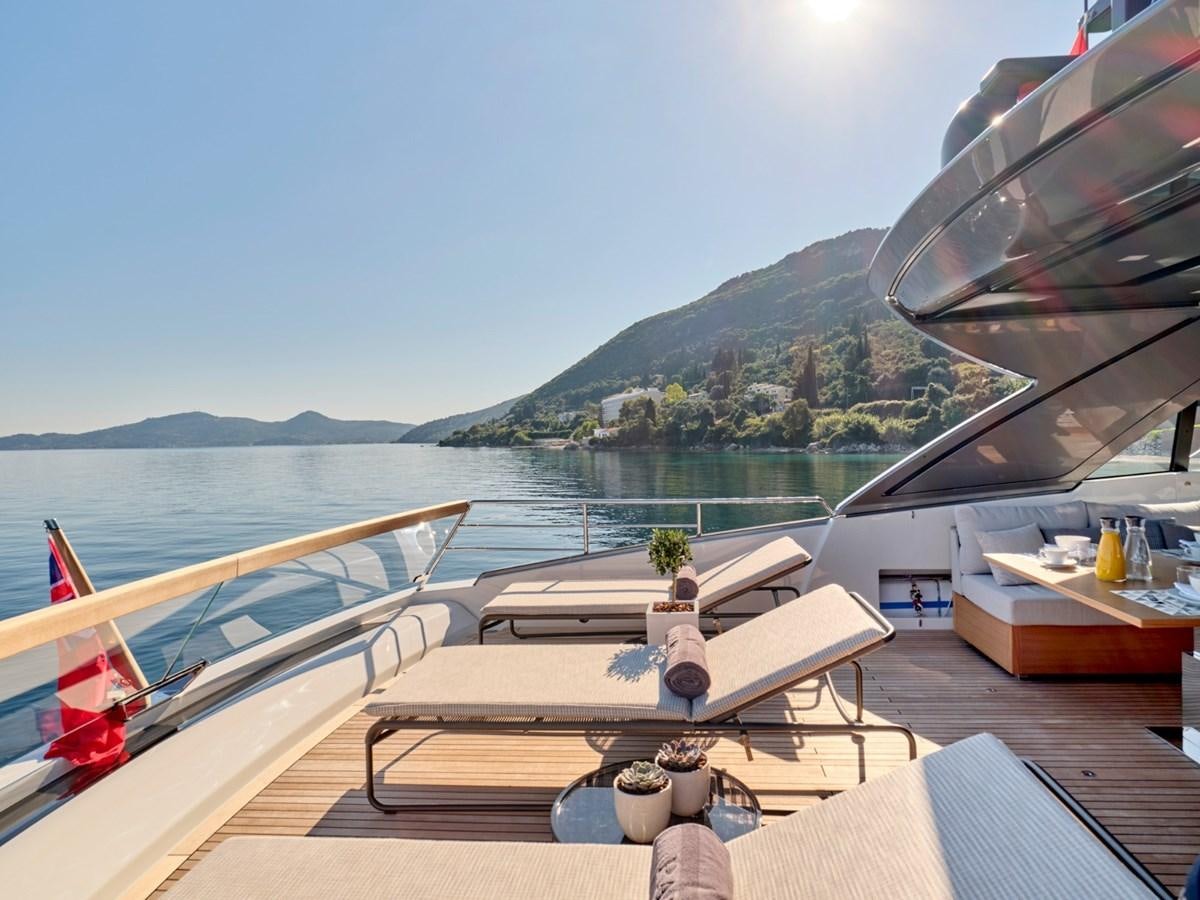 a deck with a railing and a body of water and mountains in the background aboard 2022 SANLORENZO SX76 #72 Yacht for Sale