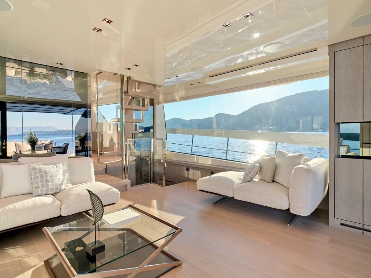 a living room with a large glass window aboard 2022 SANLORENZO SX76 #72 Yacht for Sale