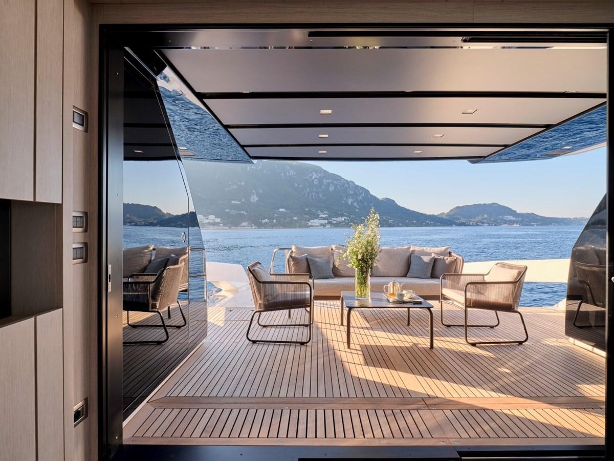 a room with a table chairs and a view of the ocean aboard 2022 SANLORENZO SX76 #72 Yacht for Sale