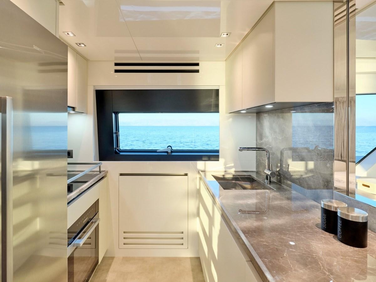 a kitchen with a large window aboard 2022 SANLORENZO SX76 #72 Yacht for Sale