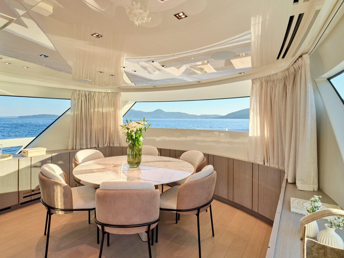 a room with a table and chairs aboard 2022 SANLORENZO SX76 #72 Yacht for Sale