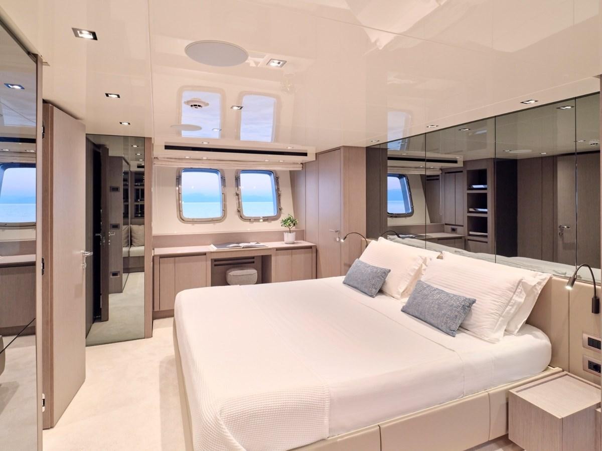 a room with a bed and a desk aboard 2022 SANLORENZO SX76 #72 Yacht for Sale