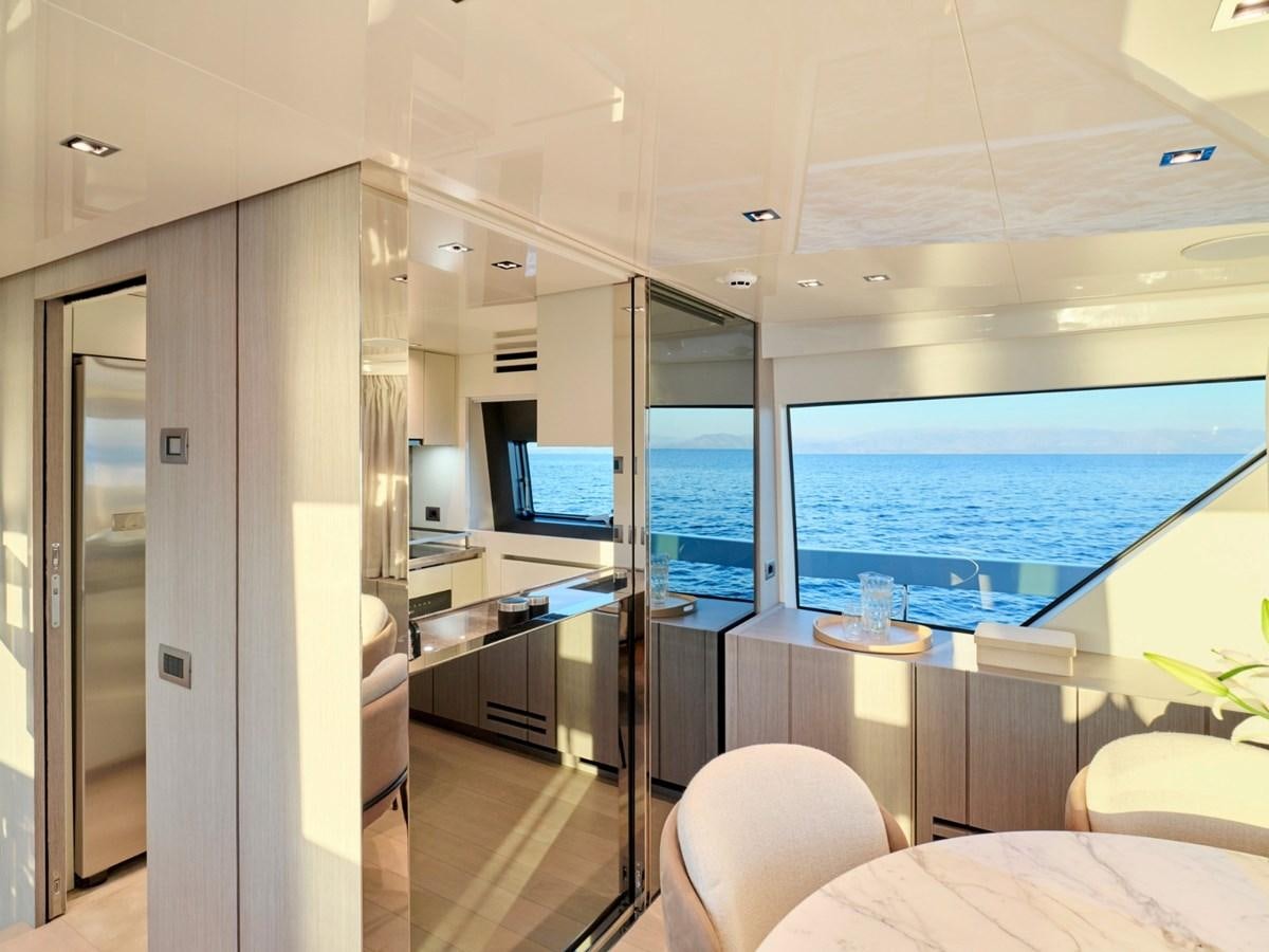 a room with a large window and a desk with a computer aboard 2022 SANLORENZO SX76 #72 Yacht for Sale