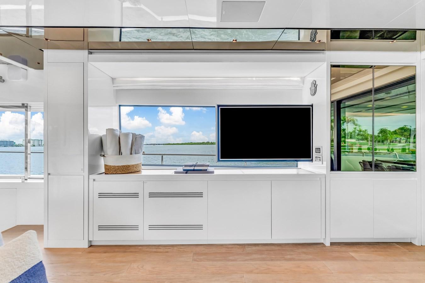 a room with a tv and cabinets aboard 2018 SANLORENZO SL78 Yacht for Sale