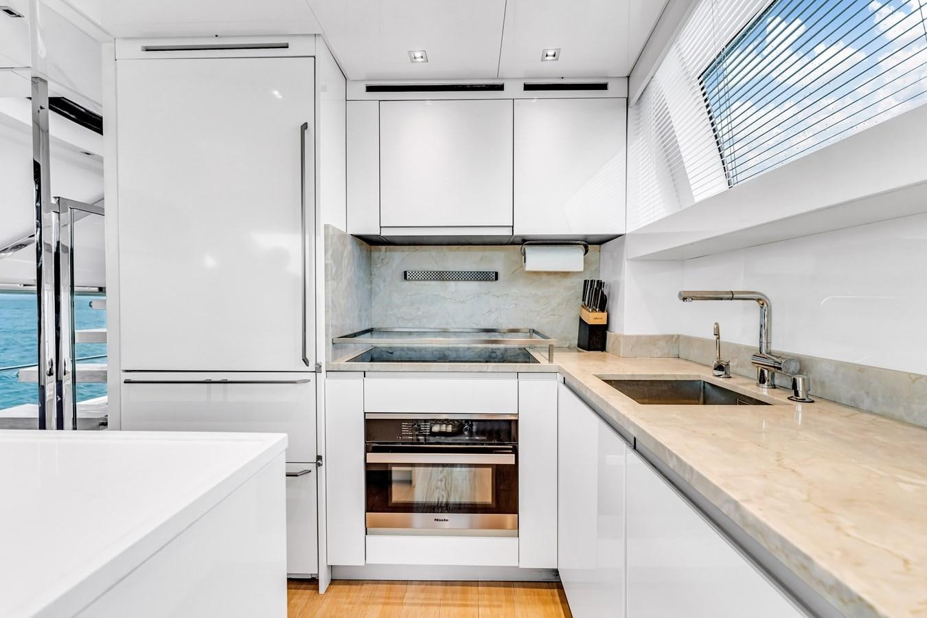 a kitchen with white cabinets aboard 2018 SANLORENZO SL78 Yacht for Sale