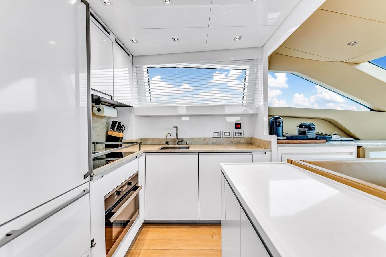 a kitchen with white cabinets aboard 2018 SANLORENZO SL78 Yacht for Sale