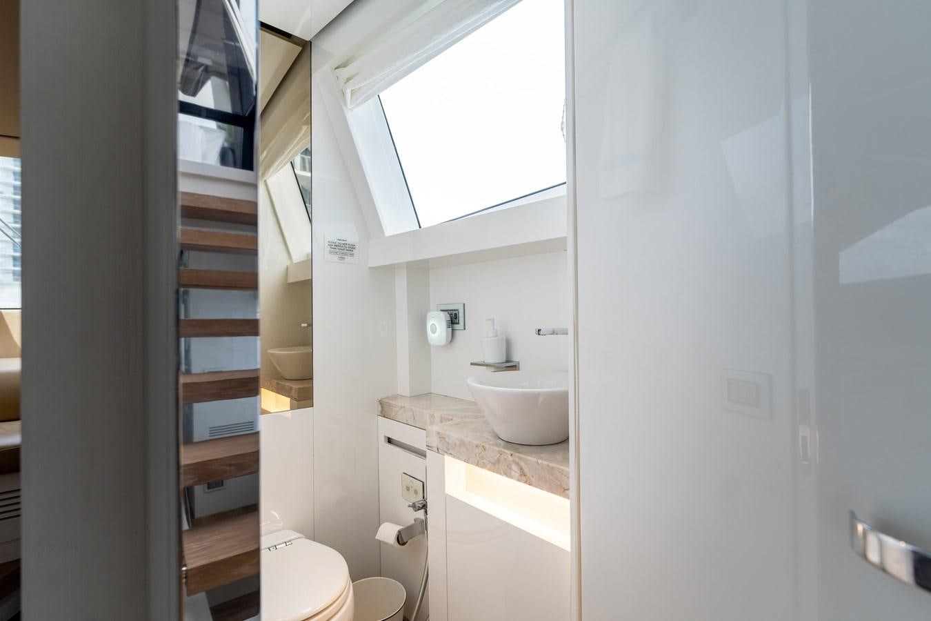 a bathroom with a white sink and a ladder aboard 2018 SANLORENZO SL78 Yacht for Sale