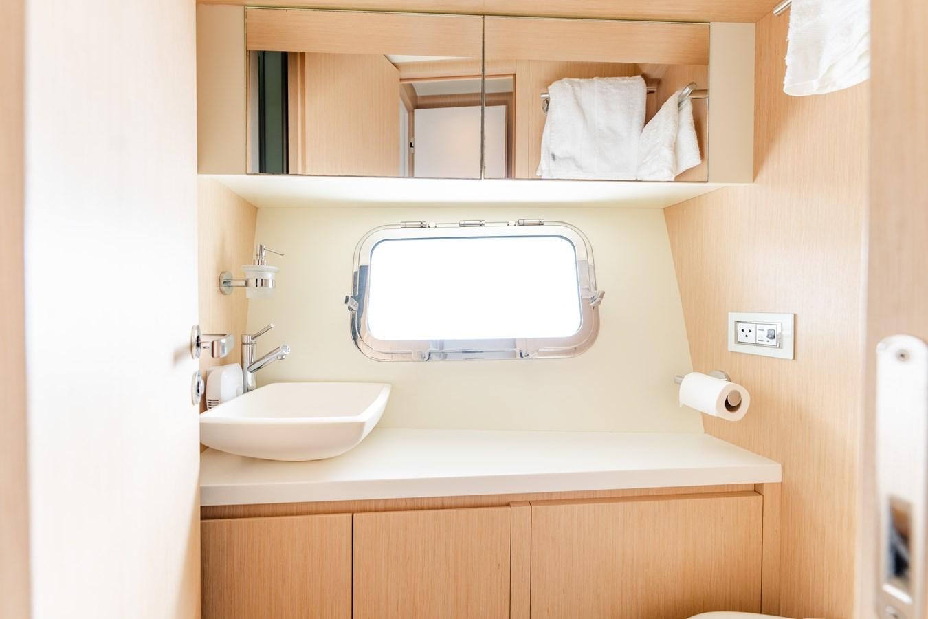 a bathroom with a sink and a mirror aboard 2018 SANLORENZO SL78 Yacht for Sale