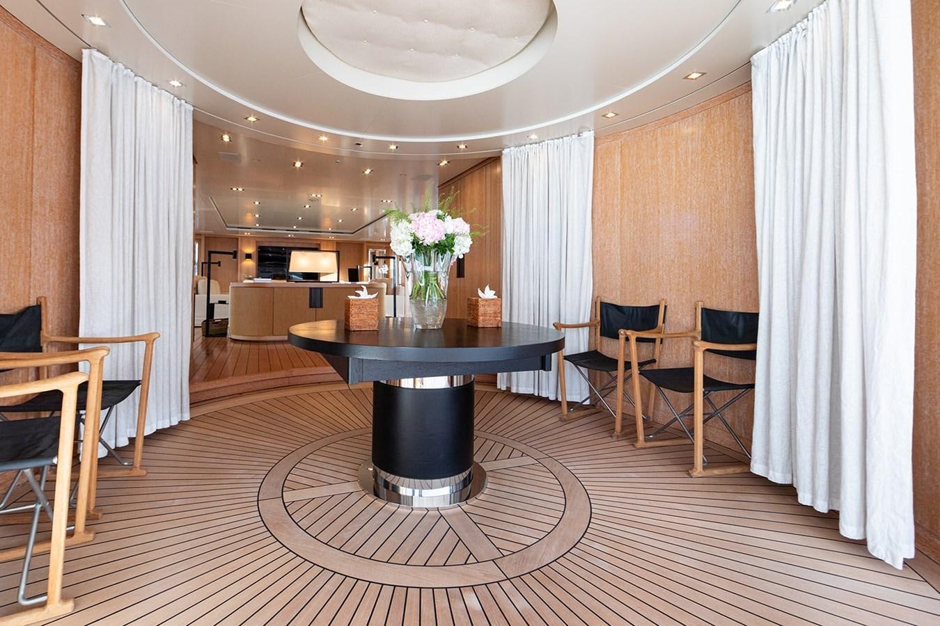 a large room with a table and chairs aboard BELONGERS Yacht for Sale