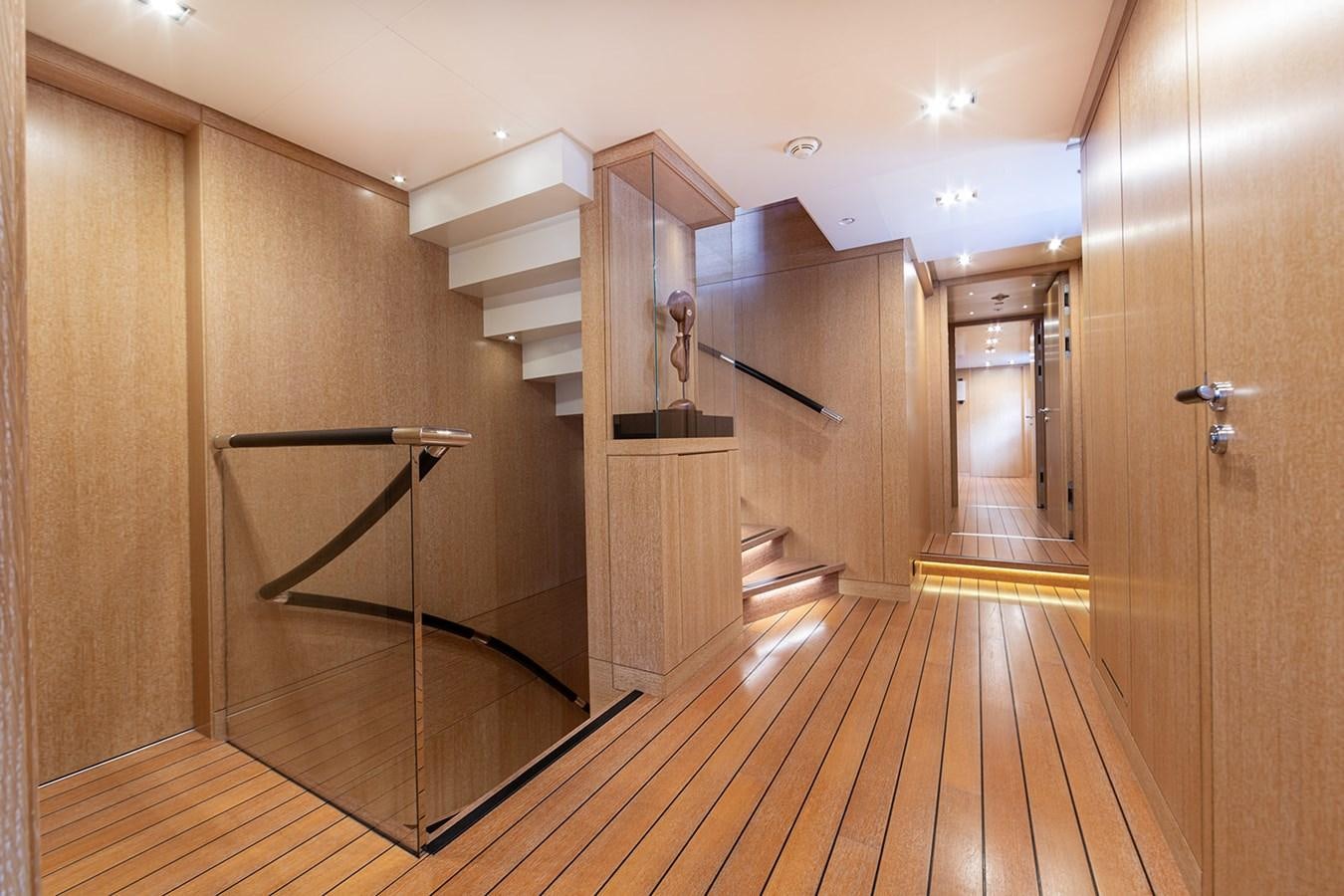 a room with wooden floors and a staircase aboard BELONGERS Yacht for Sale