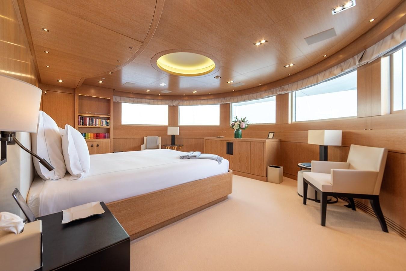 a room with a bed and a desk aboard BELONGERS Yacht for Sale