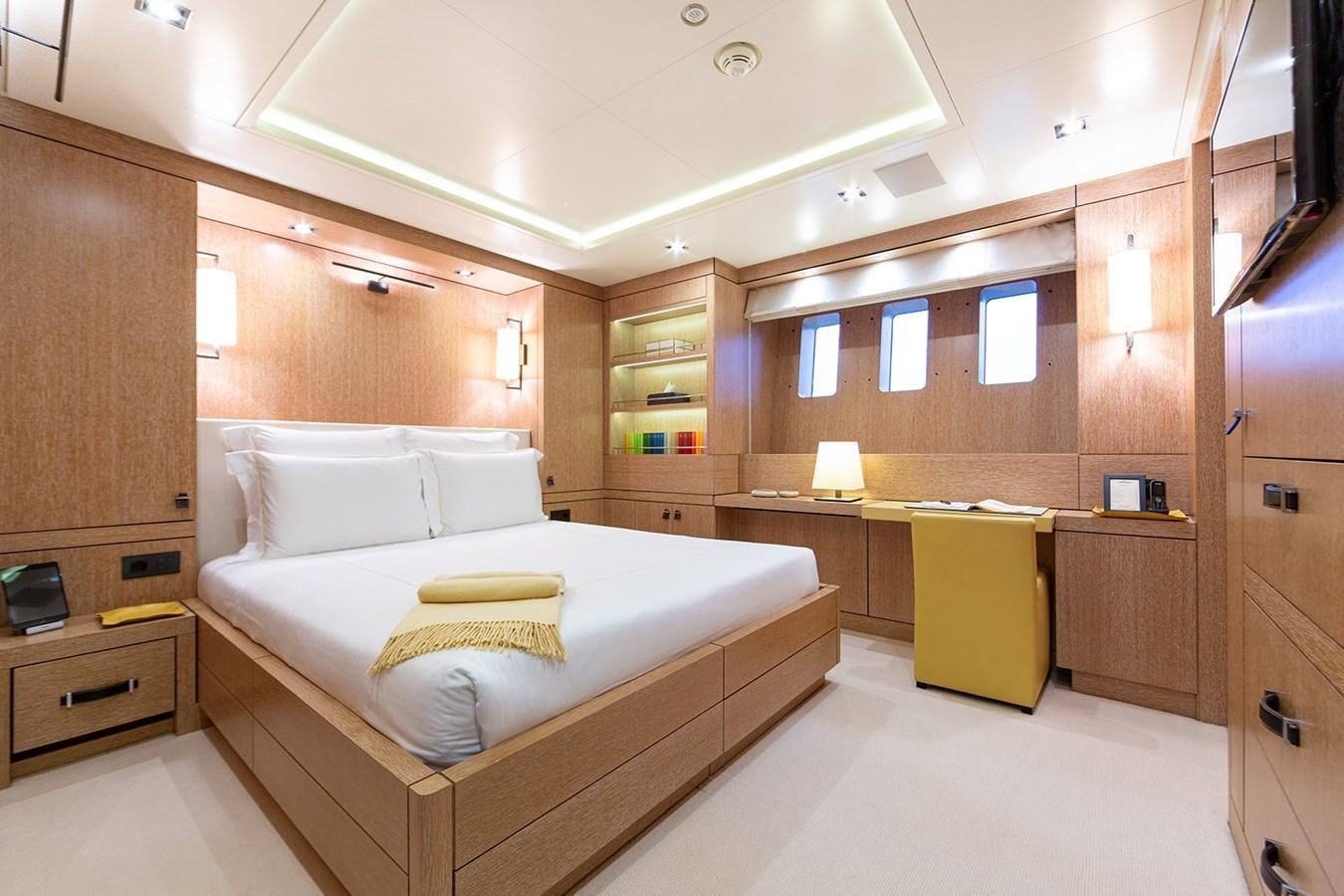 a room with a bed and a desk aboard BELONGERS Yacht for Sale