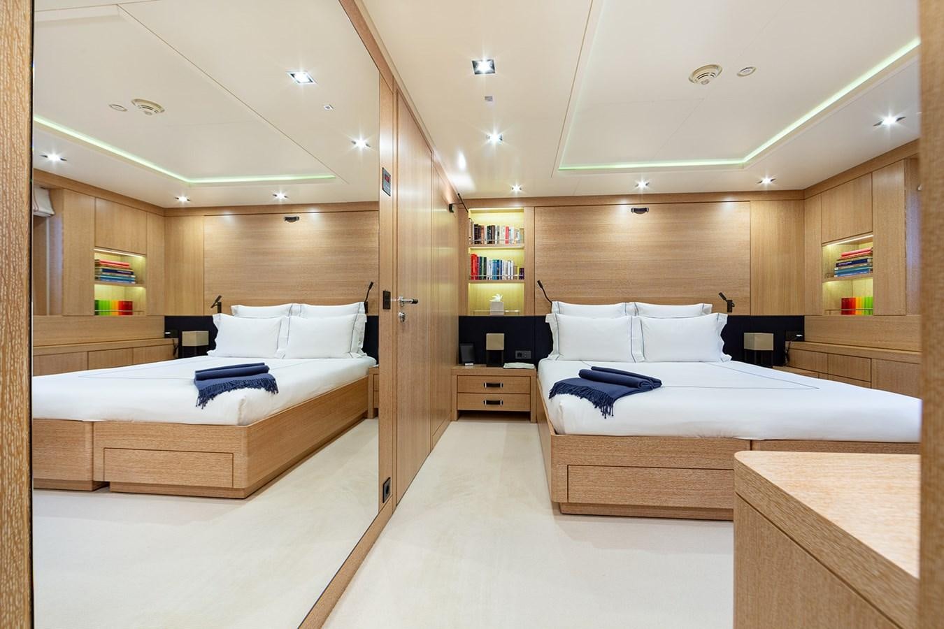 a room with a bed and a desk aboard BELONGERS Yacht for Sale