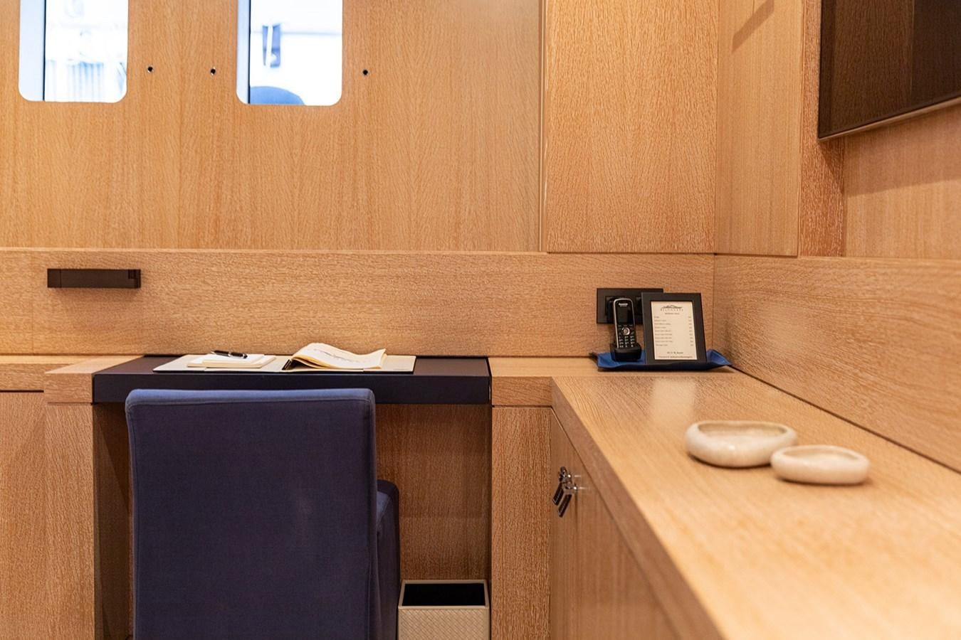 a kitchen with a black chair aboard BELONGERS Yacht for Sale