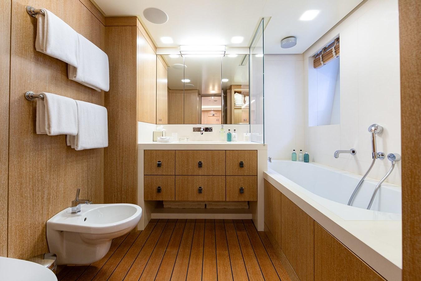 a bathroom with a tub sink and a sink aboard BELONGERS Yacht for Sale