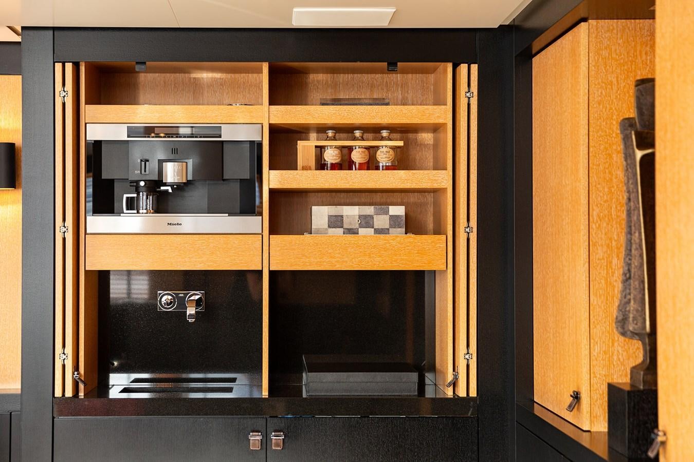 a cabinet with a glass door aboard BELONGERS Yacht for Sale