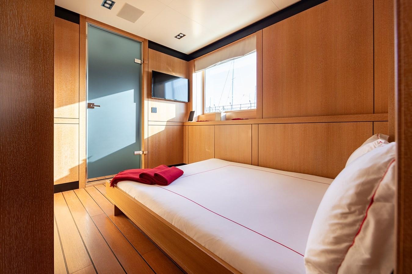 a room with a bed and a window aboard BELONGERS Yacht for Sale