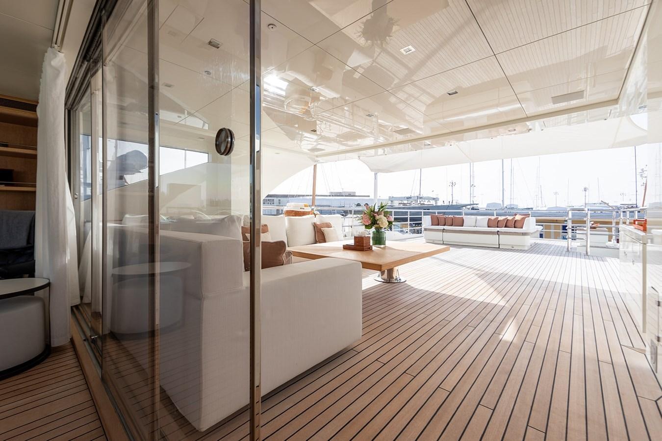 a room with a wood floor and a large window with a wood floor aboard BELONGERS Yacht for Sale